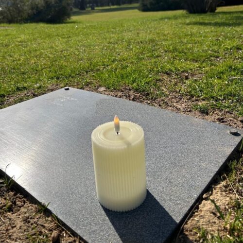 Placement of a candle on the headstone